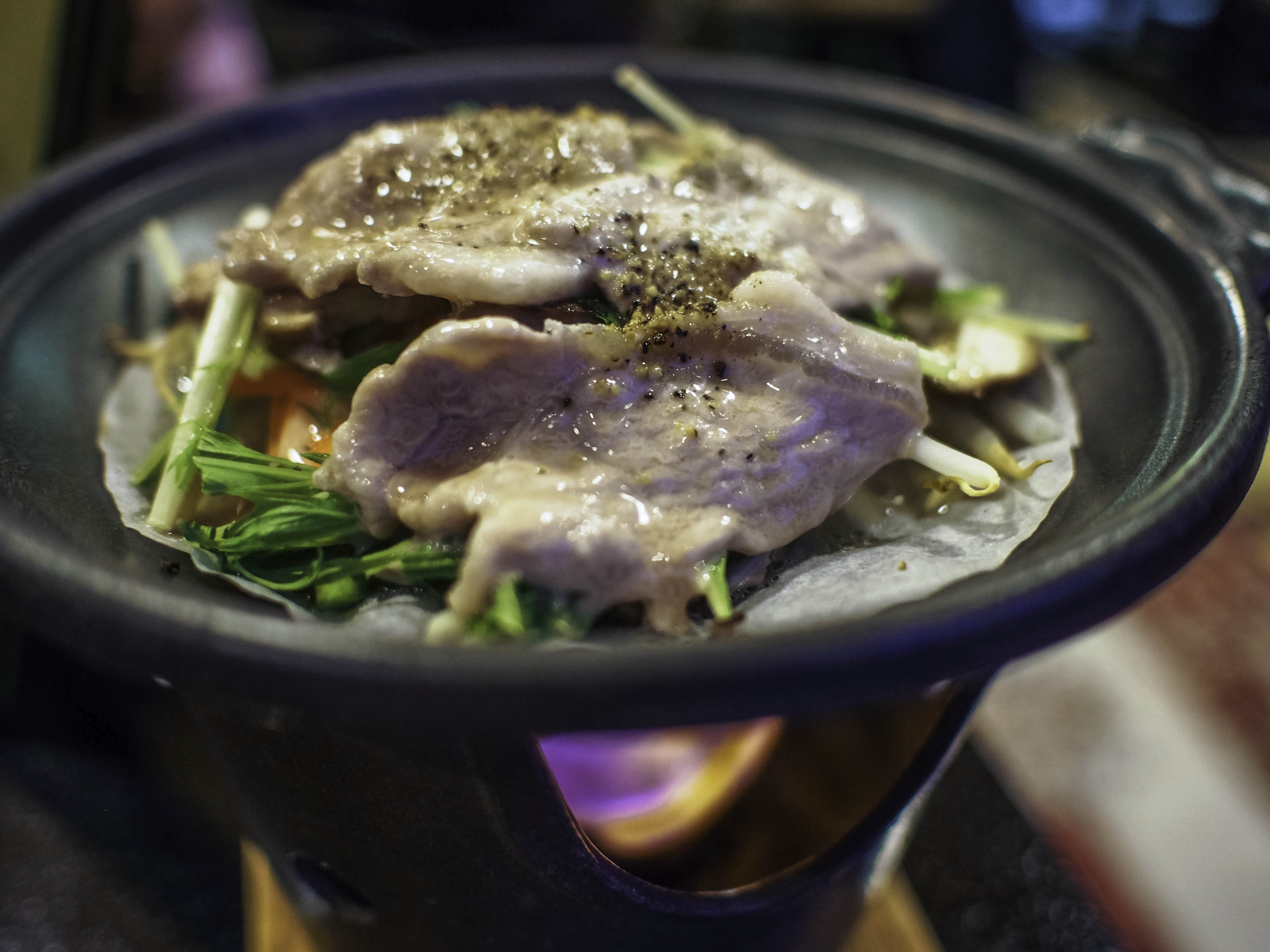 succulent pork being gently toasted over a fire