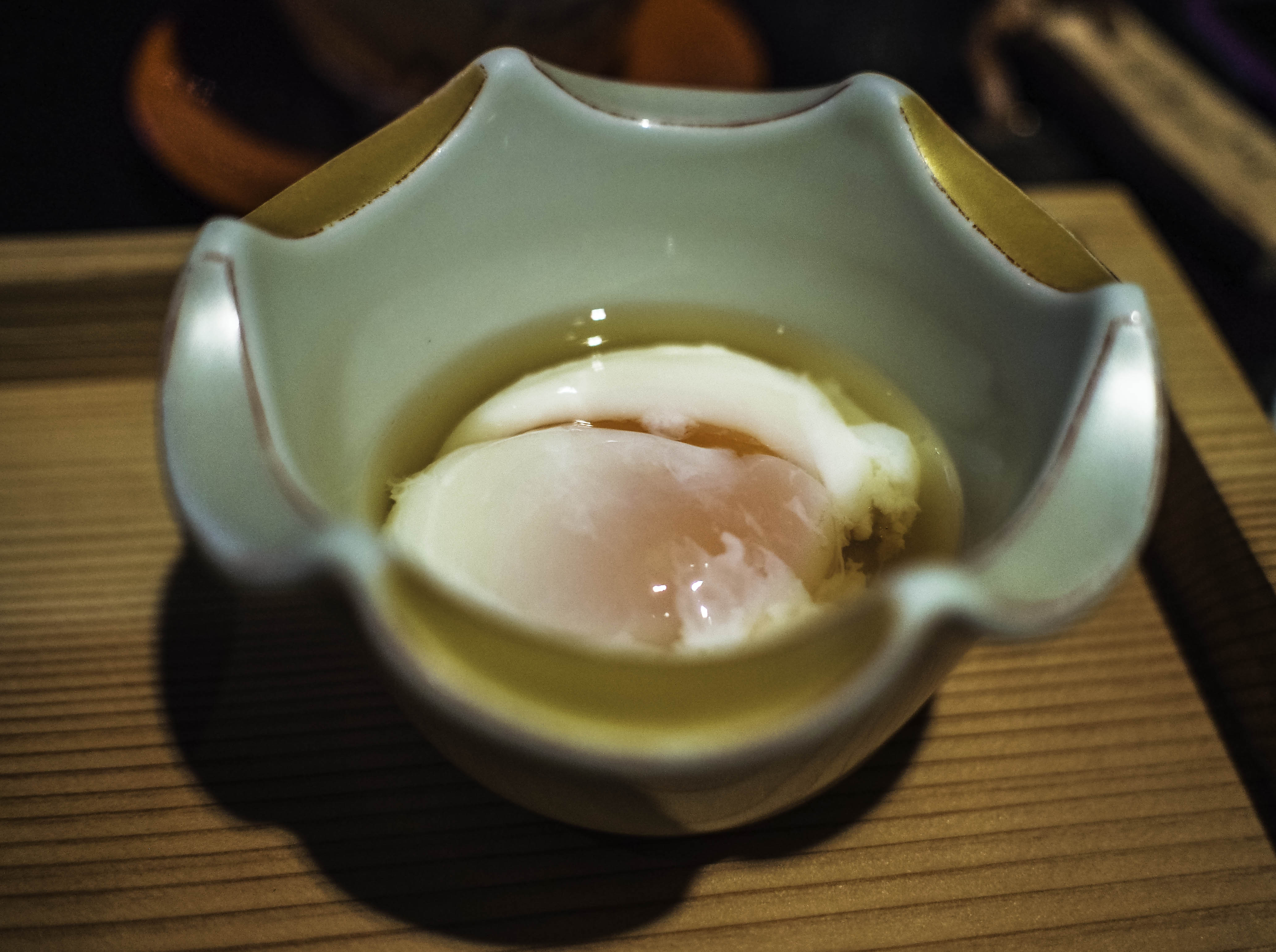 a raw egg in ceramic pot