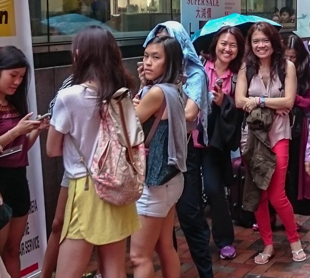 the girls braving a slight drizzle to join in the queue