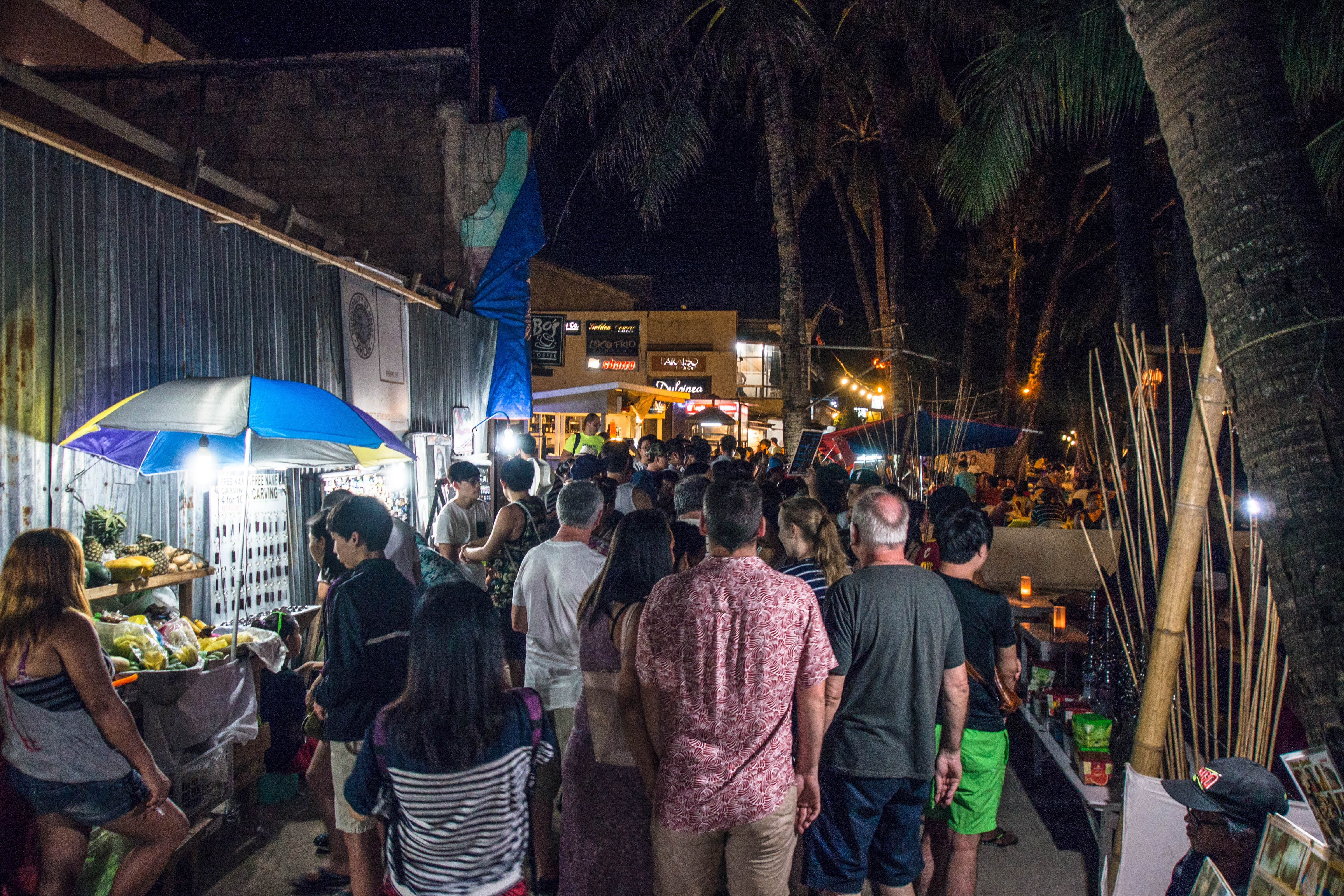 crowd along white beach on a typical night 